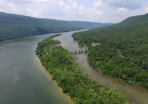 Scenic river island surrounding a peaceful tree house rental retreat.